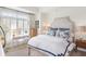Well-lit bedroom featuring a large window, white linen, and two lamps at 50 Biscayne Nw Dr # 6117, Atlanta, GA 30309