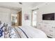 Bright bedroom with a white dresser, a sliding door, and tray ceiling at 50 Biscayne Nw Dr # 6117, Atlanta, GA 30309