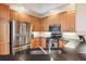 Well-lit kitchen features stainless steel appliances, wood cabinets, and black countertops at 50 Biscayne Nw Dr # 6117, Atlanta, GA 30309