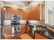 Stylish kitchen featuring stainless steel appliances, wood cabinets, and black countertops at 50 Biscayne Nw Dr # 6117, Atlanta, GA 30309
