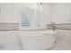 Luxurious bathroom with a freestanding tub, arched window, and decorative wall tiles at 750 Crest Valley Nw Dr, Sandy Springs, GA 30327