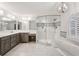 Modern bathroom with double vanity, tub, and glass shower at 750 Crest Valley Nw Dr, Sandy Springs, GA 30327