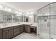 Elegant bathroom featuring a glass shower, dual sink vanity, and stylish tile flooring at 750 Crest Valley Nw Dr, Sandy Springs, GA 30327