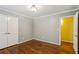 This bedroom features neutral walls, trim, and hardwood floors plus a closet at 750 Crest Valley Nw Dr, Sandy Springs, GA 30327