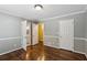 Spacious bedroom showcasing hardwood floors, natural light, and access to ensuite at 750 Crest Valley Nw Dr, Sandy Springs, GA 30327