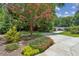 Landscaped front yard featuring a flowering tree and well-maintained lawn, leading to a charming home at 750 Crest Valley Nw Dr, Sandy Springs, GA 30327
