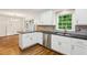Well-lit kitchen with stainless steel dishwasher and sink at 750 Crest Valley Nw Dr, Sandy Springs, GA 30327