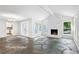 Bright living room with stone fireplace and view of kitchen at 750 Crest Valley Nw Dr, Sandy Springs, GA 30327