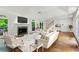 Living room with white furniture, fireplace and many windows at 750 Crest Valley Nw Dr, Sandy Springs, GA 30327