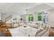 Staged living room with hardwood floors, white walls, and multiple seating areas at 750 Crest Valley Nw Dr, Sandy Springs, GA 30327