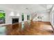Bright living room with hardwood floors, fireplace, and staircase access at 750 Crest Valley Nw Dr, Sandy Springs, GA 30327