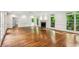 Open living room with hardwood flooring, many windows, and fireplace at 750 Crest Valley Nw Dr, Sandy Springs, GA 30327