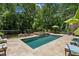 In-ground swimming pool and hot tub with paved surround and multiple seating and lounge areas at 750 Crest Valley Nw Dr, Sandy Springs, GA 30327
