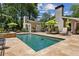 Backyard swimming pool and lounge area with stone patio, umbrellas and plenty of seating at 750 Crest Valley Nw Dr, Sandy Springs, GA 30327