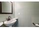 Cozy powder room with pedestal sink and bronze fixtures at 750 Crest Valley Nw Dr, Sandy Springs, GA 30327