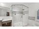 Nicely tiled shower featuring glass surround and black and white decorative tiling at 750 Crest Valley Nw Dr, Sandy Springs, GA 30327