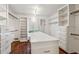Spacious walk-in closet with custom shelving, drawers, and center island at 750 Crest Valley Nw Dr, Sandy Springs, GA 30327