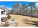 Expansive backyard featuring a lush lawn, mature trees, and a rustic black wooden fence at , Auburn, GA 30011