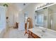 Bright bathroom featuring a white sink, wooden vanity, and tile flooring at , Auburn, GA 30011