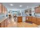 Spacious kitchen with wood cabinetry and a view into the living and dining areas, perfect for entertaining at , Auburn, GA 30011