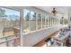 Enclosed sunroom with multiple windows offering serene views of the surrounding greenery, with cozy chairs at , Auburn, GA 30011
