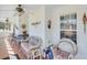 Bright sunroom with large windows, tile flooring, white paneled walls, and comfortable wicker seating at , Auburn, GA 30011