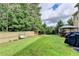 Well-maintained backyard with lush green grass, swing, hot tub and a privacy fence at 1211 Chapel Estates Way, Dacula, GA 30019