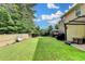 Expansive backyard with lush green grass, swing, hot tub, covered patio, and privacy fence at 1211 Chapel Estates Way, Dacula, GA 30019