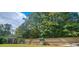 Large backyard with a privacy fence, storage shed, mature trees and a relaxing swing at 1211 Chapel Estates Way, Dacula, GA 30019
