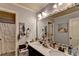 Bathroom featuring a double vanity with decorative mirror and a bathtub with a shower at 1211 Chapel Estates Way, Dacula, GA 30019