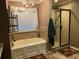 Bathroom with a soaking tub and tiled shower at 1211 Chapel Estates Way, Dacula, GA 30019