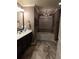 Beautiful bathroom featuring a soaking tub, glass shower, chandelier, and a marble floor at 1211 Chapel Estates Way, Dacula, GA 30019