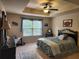 Bright bedroom featuring a decorative ceiling, ceiling fan and natural lighting at 1211 Chapel Estates Way, Dacula, GA 30019