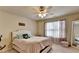 Bedroom with natural light from the window and a decorative ceiling fan with lighting at 1211 Chapel Estates Way, Dacula, GA 30019