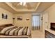 Comfortable bedroom featuring a decorative tray ceiling, carpeted floor, and neutral paint at 1211 Chapel Estates Way, Dacula, GA 30019