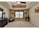 Spacious bedroom features a tray ceiling with fan, neutral walls, and natural light at 1211 Chapel Estates Way, Dacula, GA 30019