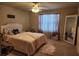 A comfortable bedroom with lots of light and soft carpet with matching pink accents and a large mirror at 1211 Chapel Estates Way, Dacula, GA 30019