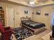 Clean bedroom with natural light, with built in shelving and dark geometric area rug at 1211 Chapel Estates Way, Dacula, GA 30019