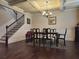 Formal dining room boasts elegant wainscoting, coffered ceiling, and hardwood floors adjacent to the staircase at 1211 Chapel Estates Way, Dacula, GA 30019
