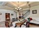 Formal dining room with coffered ceilings, wainscoting, chandelier, hardwood floors, and staircase at 1211 Chapel Estates Way, Dacula, GA 30019