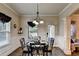 Cozy dining room with wainscoting, hardwood floors, and an elegant chandelier at 1211 Chapel Estates Way, Dacula, GA 30019