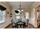 Elegant dining room with natural light, decorative chair rail and detailed trim at 1211 Chapel Estates Way, Dacula, GA 30019