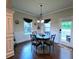 Cozy breakfast nook featuring a round table, stylish chairs, and natural light from surrounding windows at 1211 Chapel Estates Way, Dacula, GA 30019
