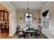 Dining area features a chandelier, hardwood floors, and detailed trim work at 1211 Chapel Estates Way, Dacula, GA 30019