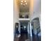 Spacious entryway with soaring ceilings, elegant staircase and dark hardwood flooring throughout main floor at 1211 Chapel Estates Way, Dacula, GA 30019