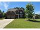 Charming two-story brick home with a well-maintained lawn, two-car garage, and inviting front entrance at 1211 Chapel Estates Way, Dacula, GA 30019
