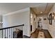 Hallway with hardwood floors, wainscoting, and access to multiple rooms in the house at 1211 Chapel Estates Way, Dacula, GA 30019