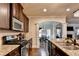 Beautiful kitchen with granite countertops, stainless steel appliances, and dark cabinetry at 1211 Chapel Estates Way, Dacula, GA 30019