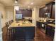 The kitchen features an island with a countertop, wood cabinets, and stainless steel appliances at 1211 Chapel Estates Way, Dacula, GA 30019