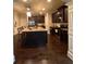 Beautiful kitchen boasting wood cabinets, a large island, stainless steel appliances, and a hardwood floor at 1211 Chapel Estates Way, Dacula, GA 30019